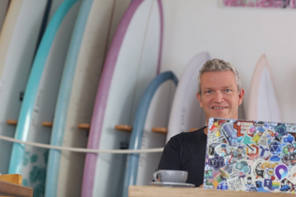 Paul Keijzers working with surfboards in background